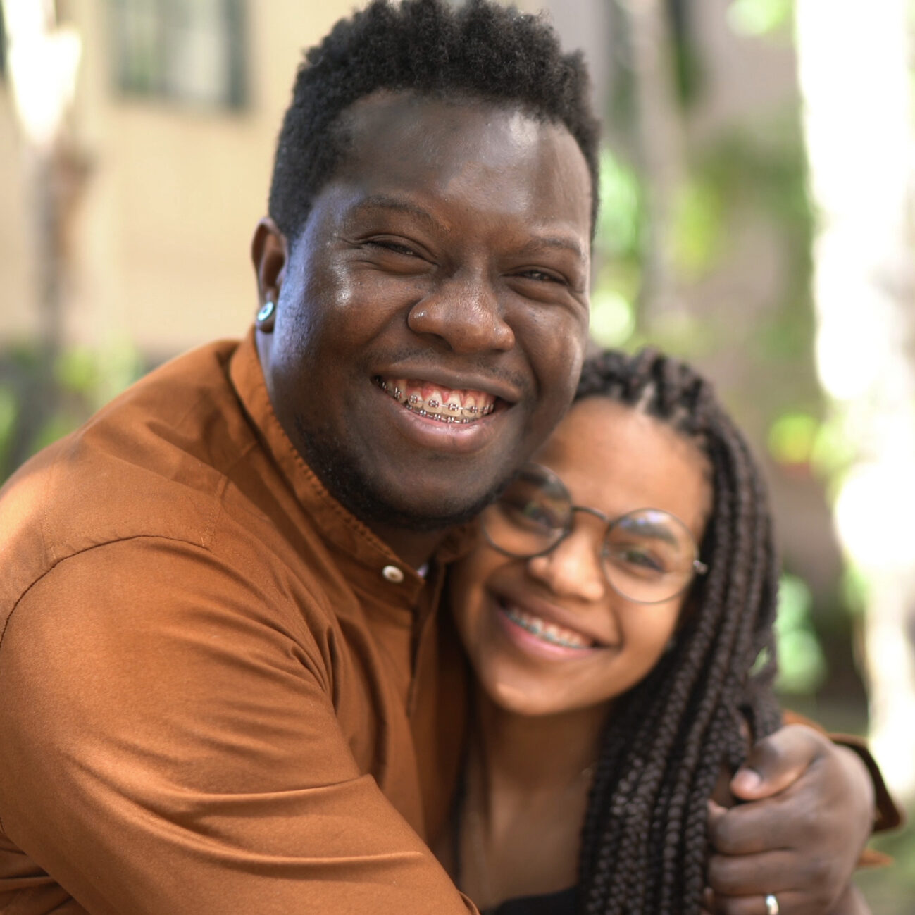 Portrait Of Father And Daughter Embracing Outside